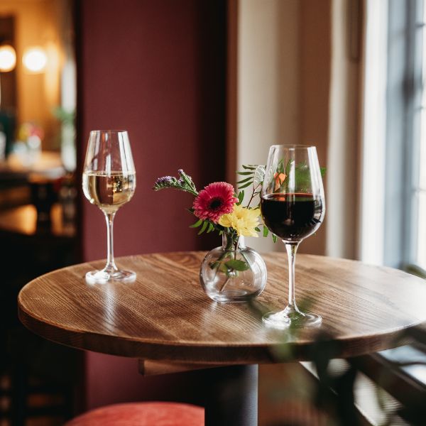 two glasses of wine; 1 white the other red, to be enjoyed